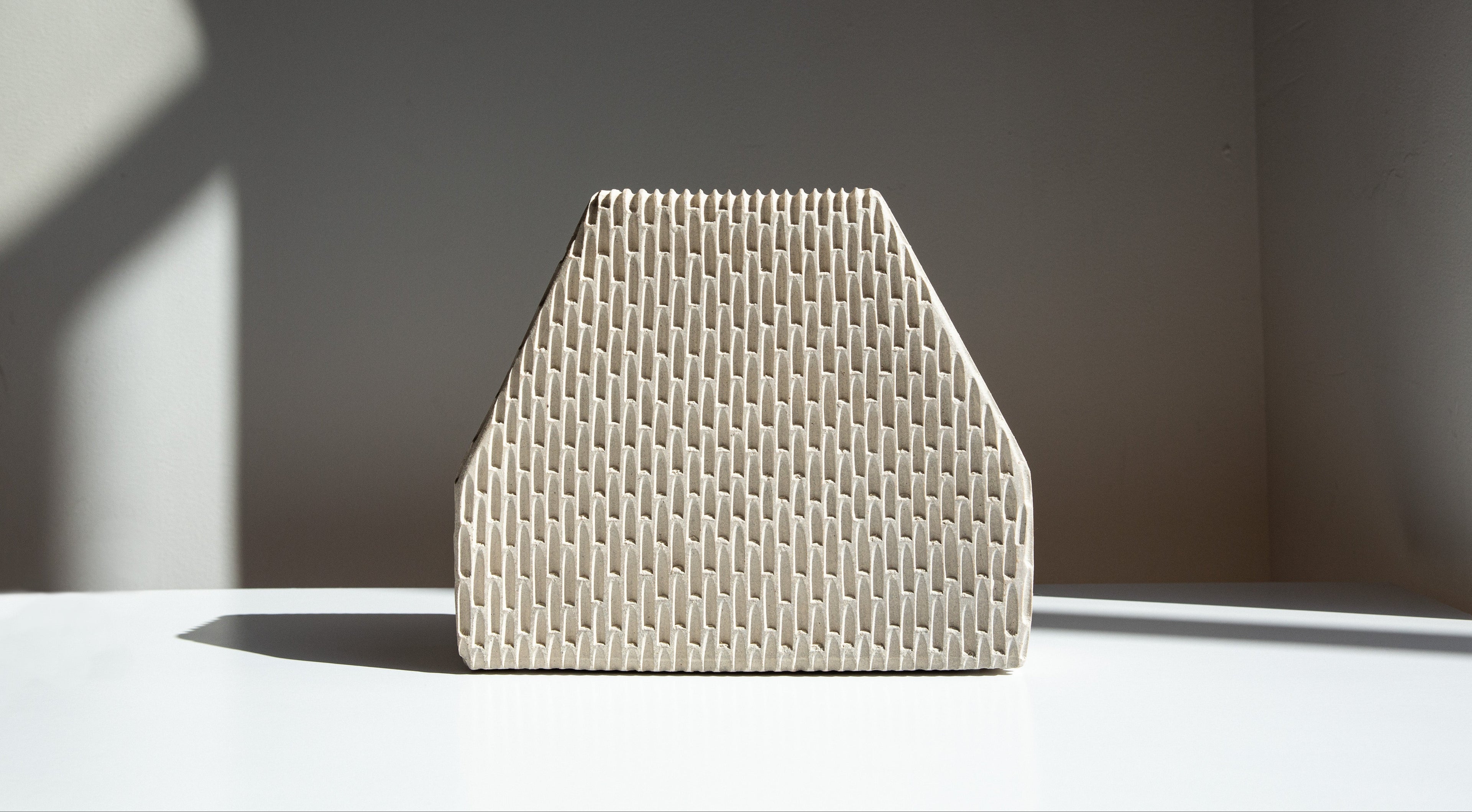 Textured ceramic vase on a neutral background